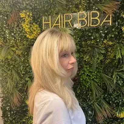 Platinum blonde hair with a full fringe