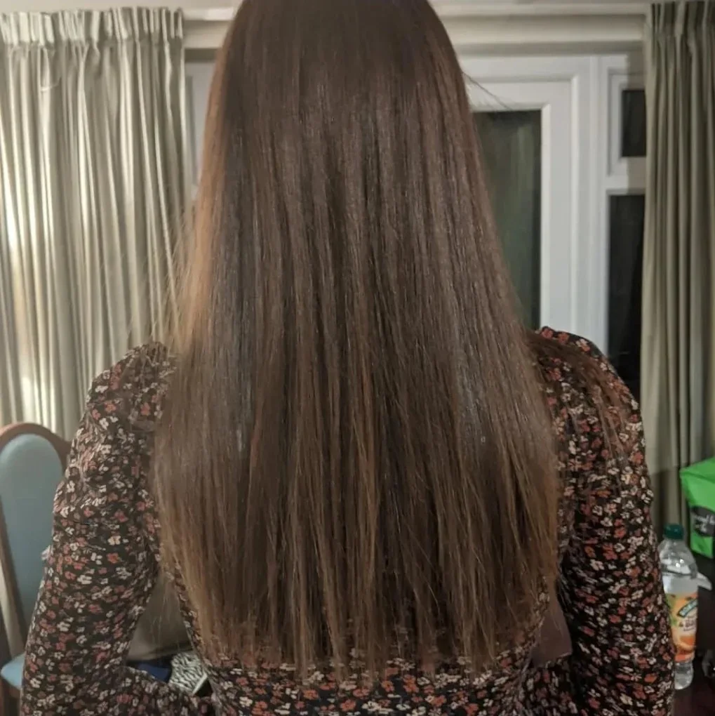 Long, glossy brunette hair after a cut and treatment