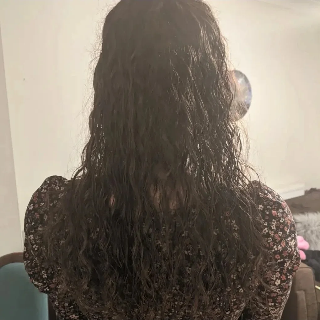 Dark hair finished in soft waves after a cut and blow dry