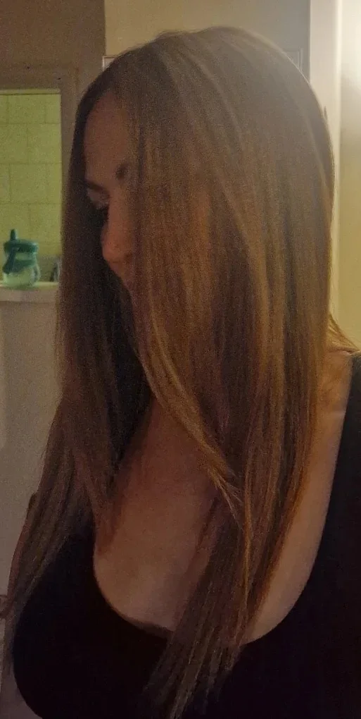 Caramel balayage on long dark hair, side view