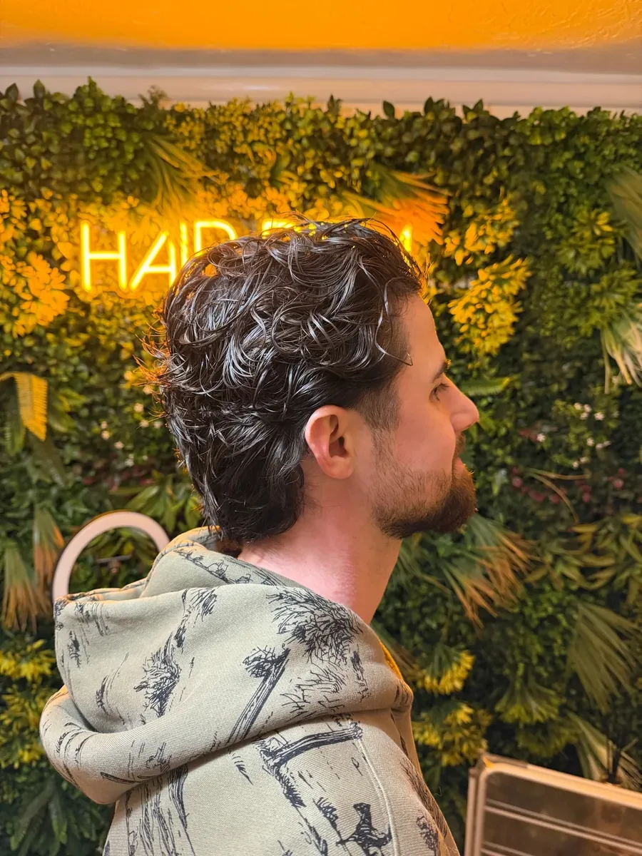 Men's textured perm, side profile, in the home salon