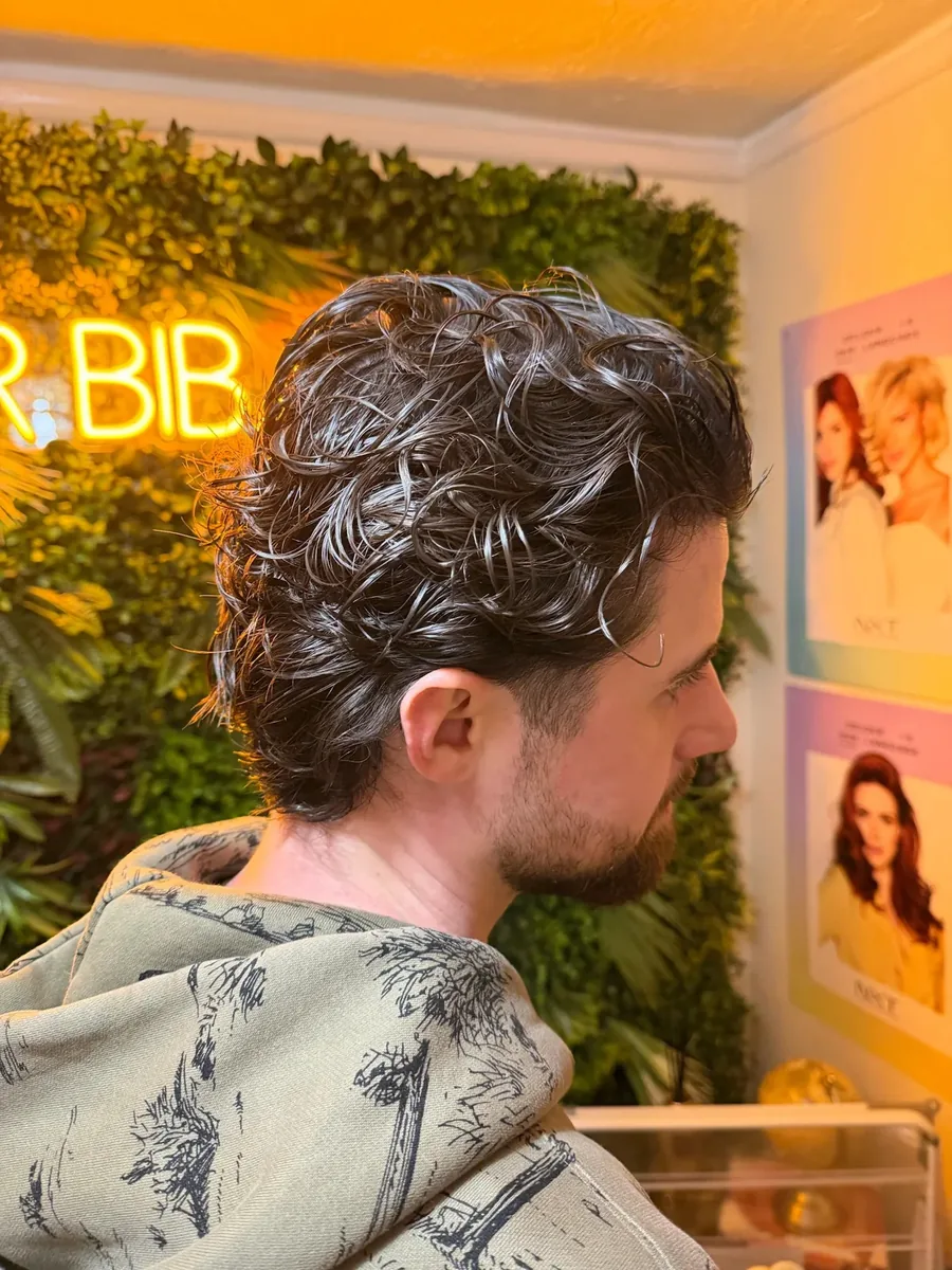 Men's perm photographed from behind